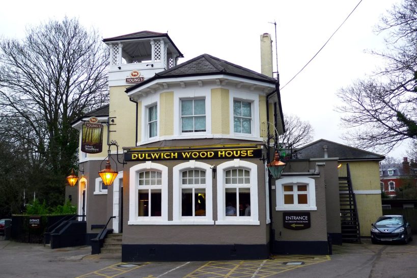 Taxi Service in Sydenham, SE26 A quaint pub with a distinctive facade and outdoor seating area.