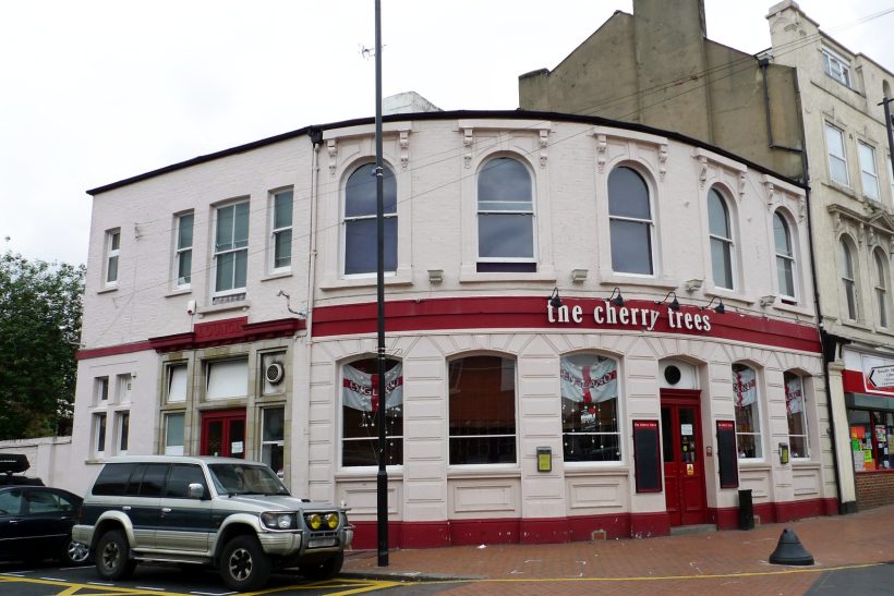 Taxi Service in South Norwood, SE25 Light pink pub with red detailing, located on a corner, featuring large windows.